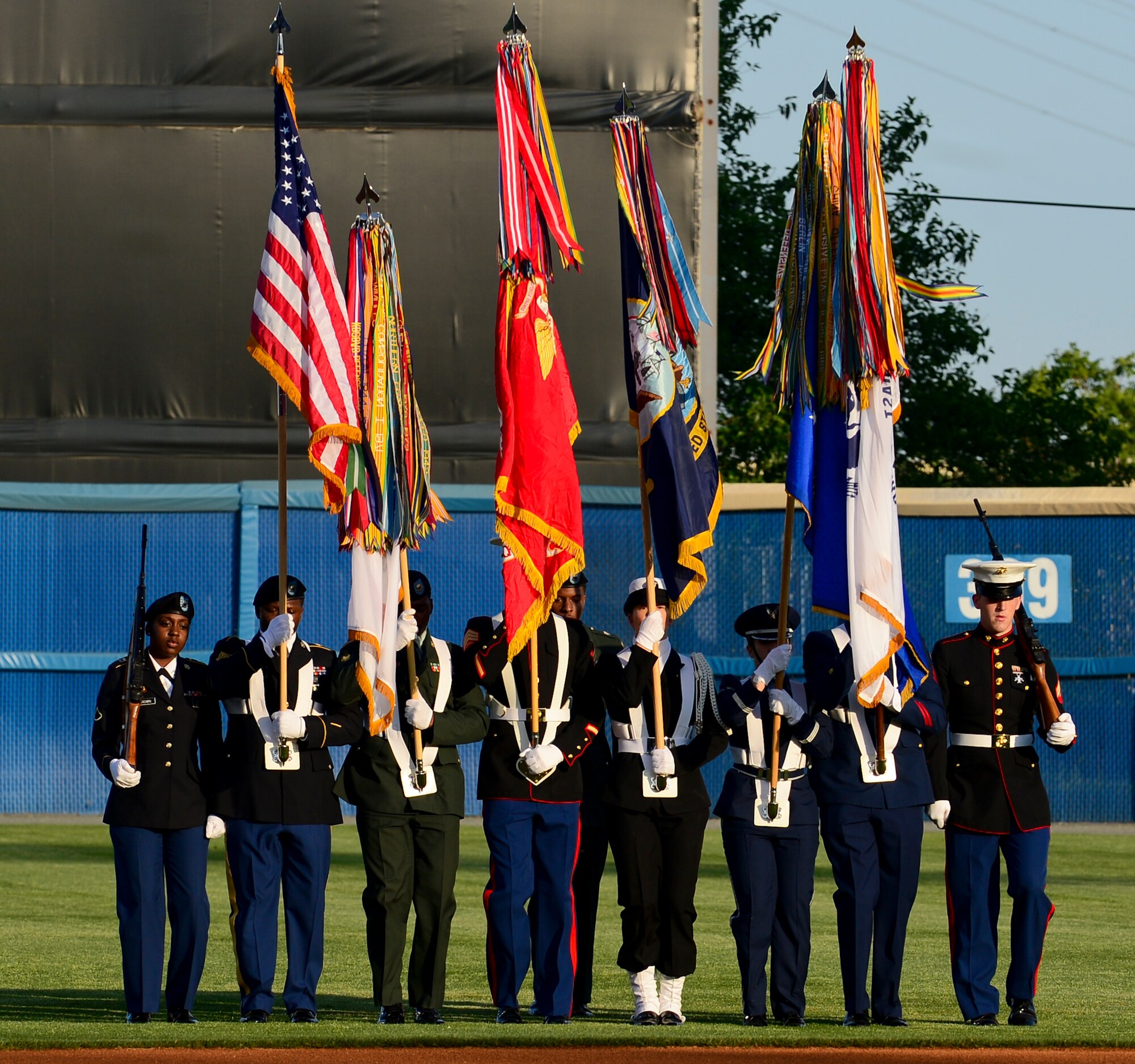 The Joint Services Color Guard presents the colors at the Norfolk Tides Armed Forces Night at Harbor Park in Norfolk, Va., May 17, 2013. The night included an Oath of Enlistment for members of the Delayed Entry Program, playing of the national anthem by the U.S. Army Training and Doctrine Command Band and six superior performers from each branch of the military throwing the first pitch of the game. (U.S. Air Force photo by Senior Airman Kayla Newman/Released)