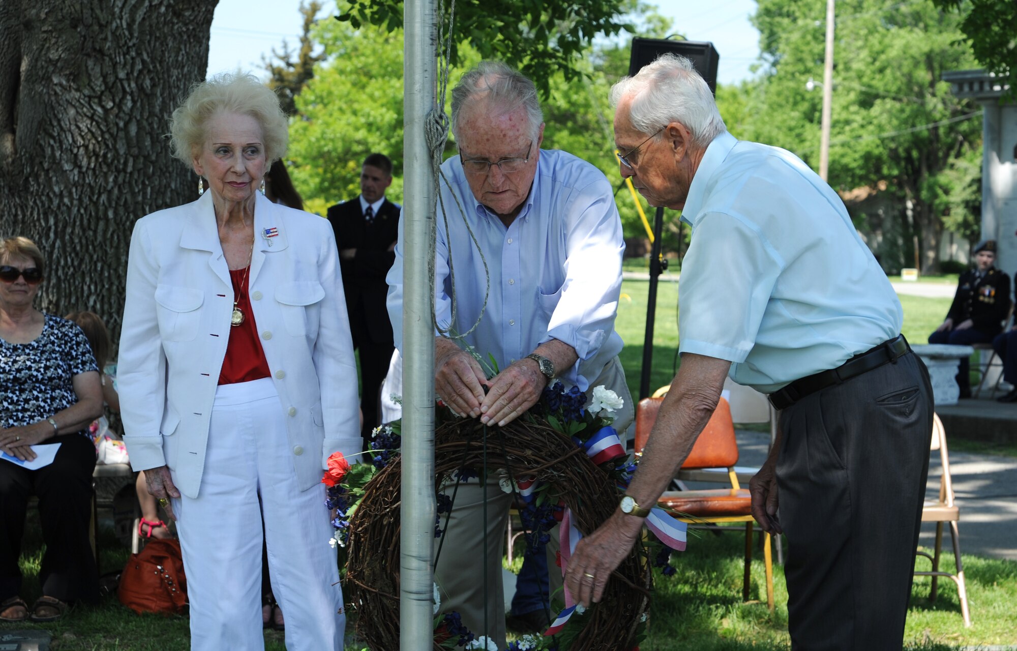 Eva Myers, James Callis and John Rucker lay the wreath at 2nd Lt. George Whiteman’s graveside during an annual ceremony May 18, 2013, in Sedalia, Mo. All three of them were also present at the first wreath-laying ceremony 25 years ago. (U.S. Air Force photo by Senior Airman Brigitte N. Brantley/Released)