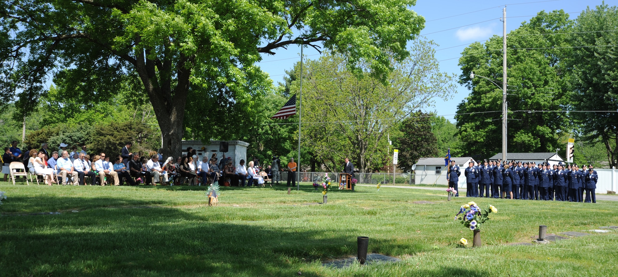 Family, community members and Airmen from Whiteman Air Force Base attend the 25th annual wreath-laying ceremony for 2nd Lt. George Whiteman May 18, 2013, in Sedalia, Mo. The base was renamed in Whiteman’s honor 14 years after he became one of the first Airmen to die during World War II. (U.S. Air Force photo by Senior Airman Brigitte N. Brantley/Released)
