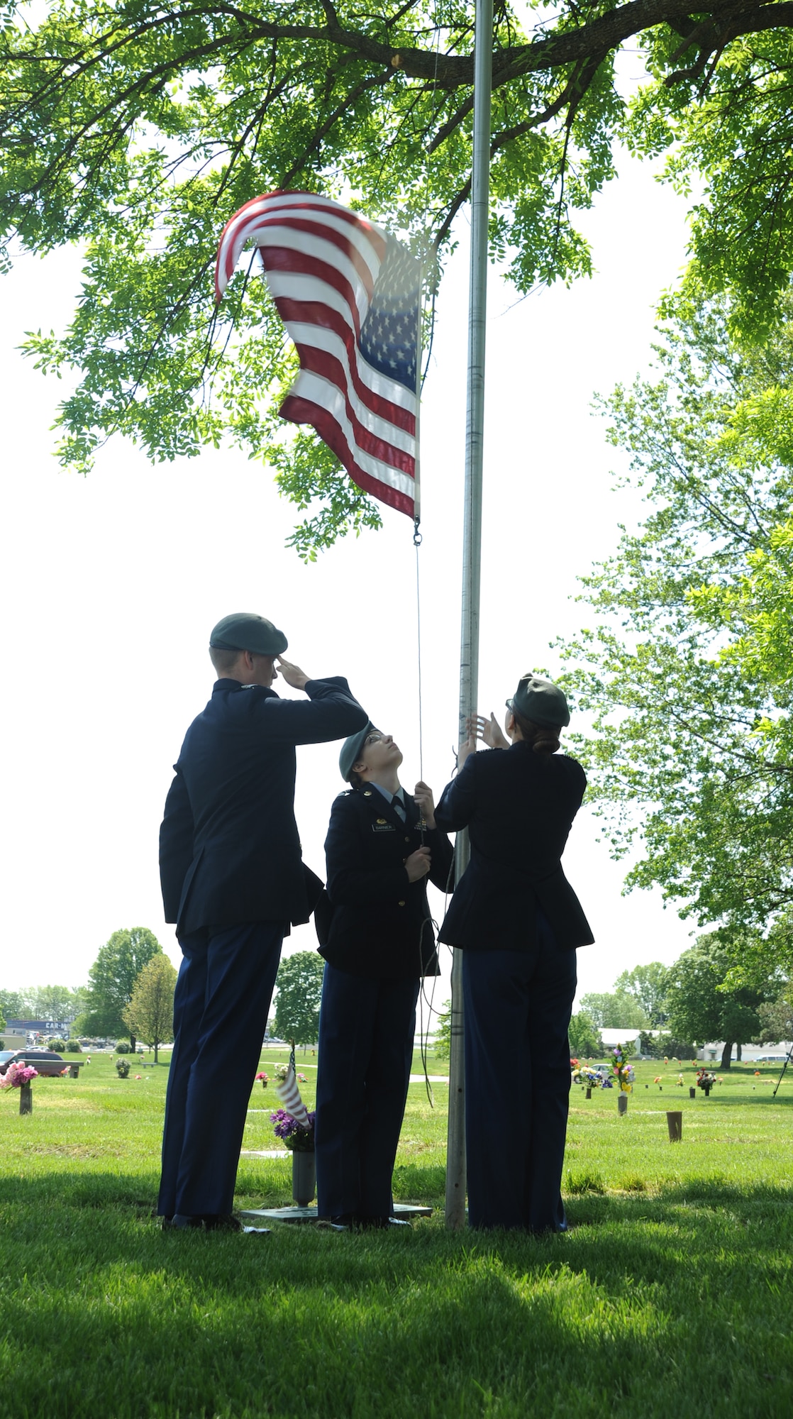 Cadets from the Sedalia Army Junior ROTC Honor Guard raise a ceremonial flag to half-staff during a wreath-laying ceremony for 2nd Lt. George Whiteman May 18, 2013, in Sedalia, Mo. The cadets are also from Smith-Cotton High School, where Whiteman graduated from before enlisting in the Air Force. (U.S. Air Force photo by Senior Airman Brigitte N. Brantley/Released)