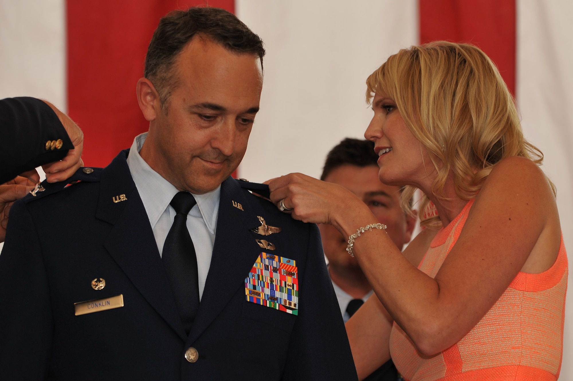 Before assuming command of the 140th Operations Group, Lieutenant Col. Timothy Conklin was promoted to the rank of colonel. His wife, Emily helps pin his new rank onto his uniform during the ceremony May 18 at Buckley AFB, Colo. (U.S. Air National Guard photo by Tech. Sgt Wolfram Stumpf)
