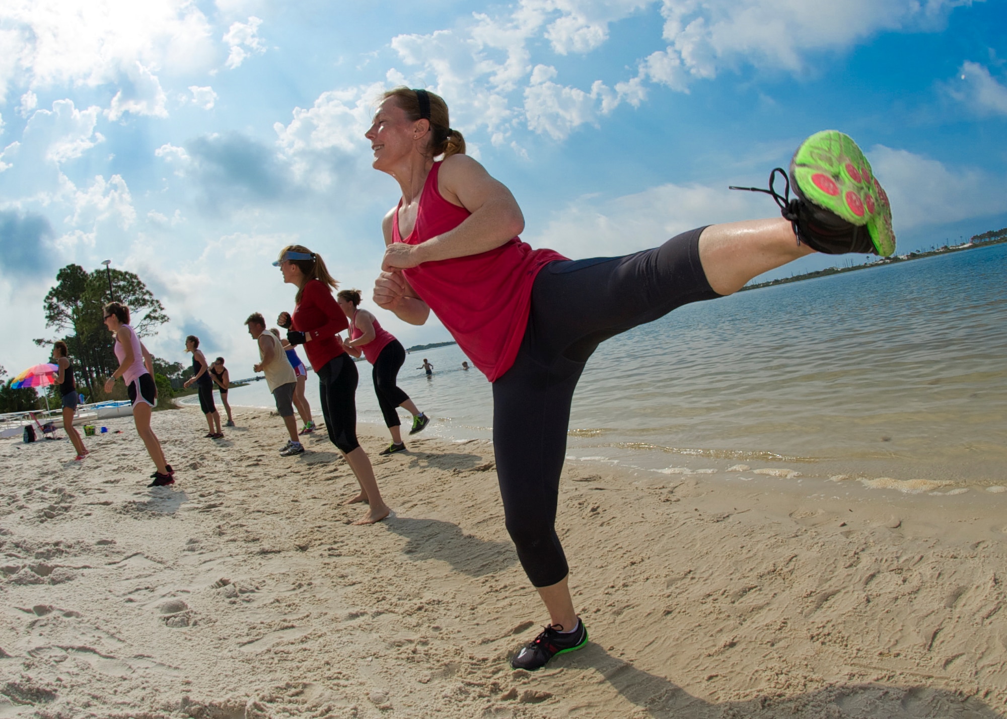 U.S. Air Force Chief Master Sgt. KarenThomas, superintendant for 1st Special Operations Force Support Squadron, side kicks during beach boot camp at Soundside Beach on Hurlburt Field, Fla., May 18, 2013. Beach boot camp class consisted of several circuit training sessons, designed to challenge participants to push past plateaus. (U.S. Air Force Photo/ Staff Sgt. John Bainter)