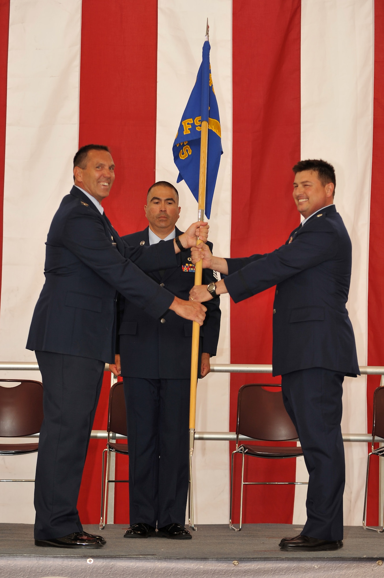 Col. Jim Fogle, commander, 140th Operations Group, passes the 120th Fighter Squadron guidon to Lieutenant Col. Patrick Hanlon, the new 120 FS commander, during a ceremony May 18 at Buckley AFB, Colo. (U.S. Air National Guard photo by Tech. Sgt Wolfram Stumpf)