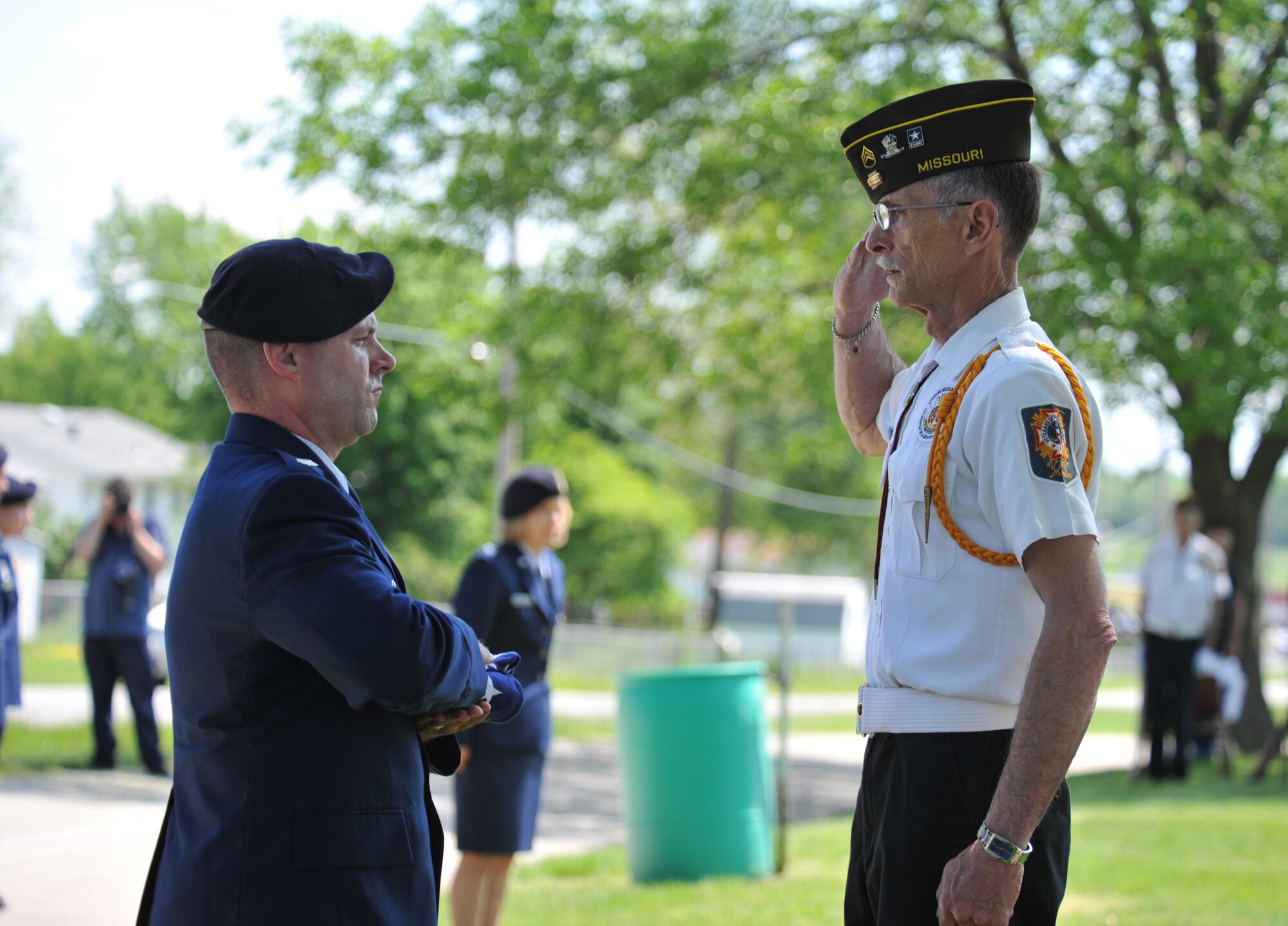 Joe Cochran, president of the local Veterans of Foreign Wars, salutes the flag held by Lt. Col. Christopher Neiman, 509th Security Forces Squadron commander, during a wreath-laying ceremony for 2nd Lt. George Whiteman May 18, 2013, in Sedalia, Mo. Whiteman, who was born in Sedalia in 1919, died during the attack on Pearl Harbor on Dec. 7, 1941. (U.S. Air Force photo by Senior Airman Brigitte N. Brantley/Released)