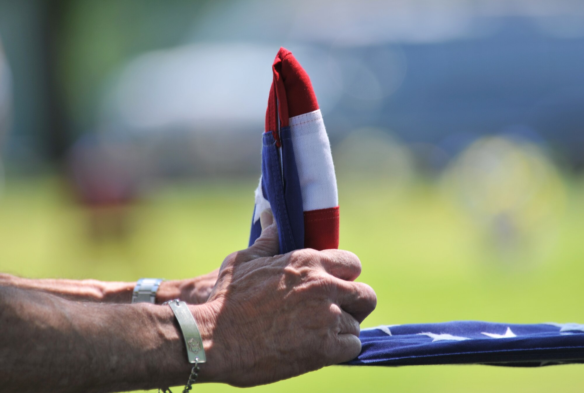 The flag from 2nd Lt. George Whiteman’s annual wreath-laying ceremony is folded by local Veterans of Foreign Wars May 18, 2013, in Sedalia, Mo. Nearby Whiteman Air Force Base was named in the young lieutenant’s honor in 1955 after he died during World War II. (U.S. Air Force photo by Senior Airman Brigitte N. Brantley/Released)