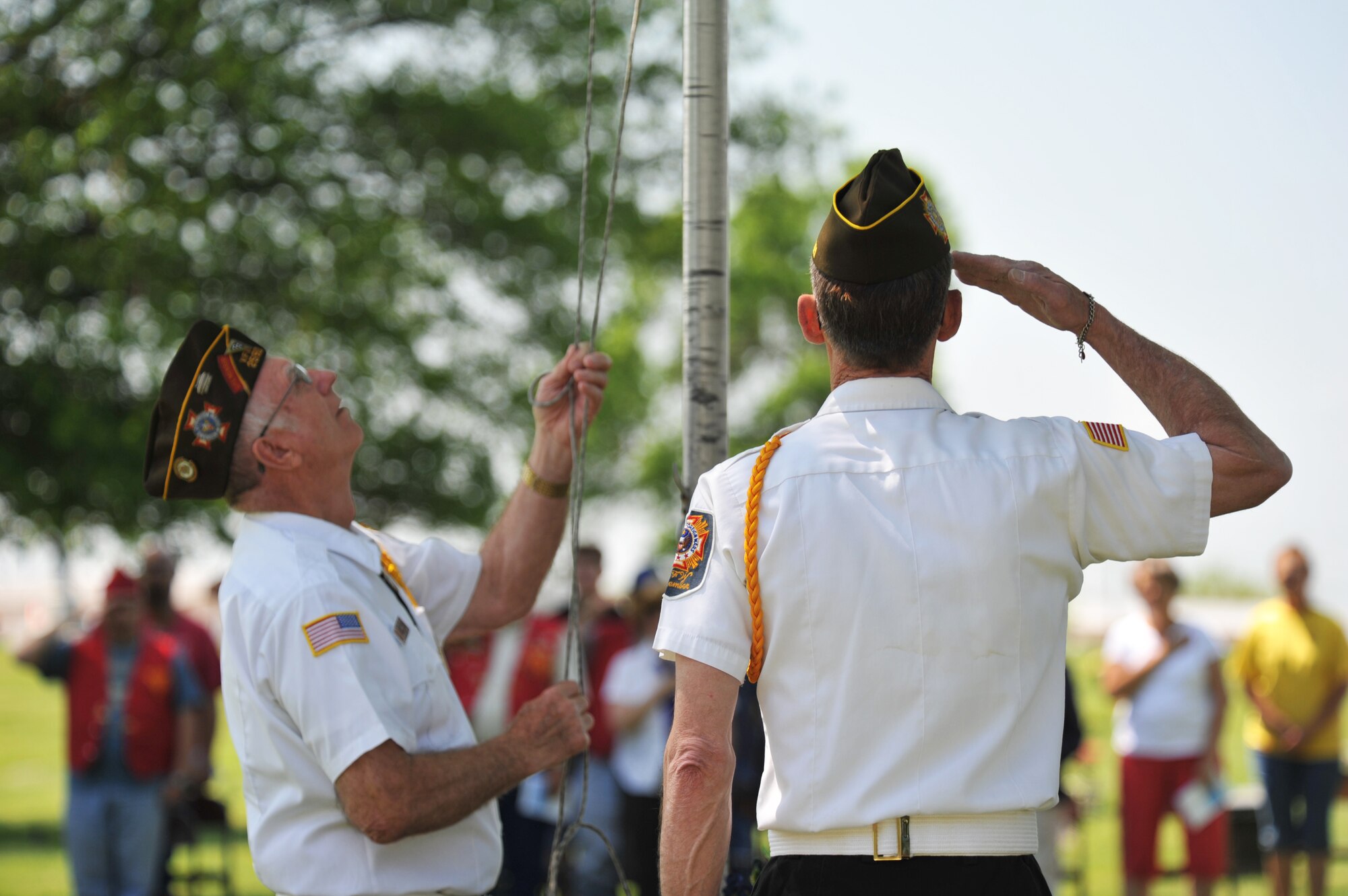Von Holton, left, and Joe Cochran, local Veterans of Foreign Wars members, lower the flag during the 25th annual wreath-laying ceremony for 2nd Lt. George Whiteman May 18, 2013, in Sedalia, Mo. Both Holton and Cochran have attended many of the ceremonies honoring Whiteman, a pilot who was one of the first Airmen to die during World War II. (U.S. Air Force photo by Senior Airman Brigitte N. Brantley/Released)