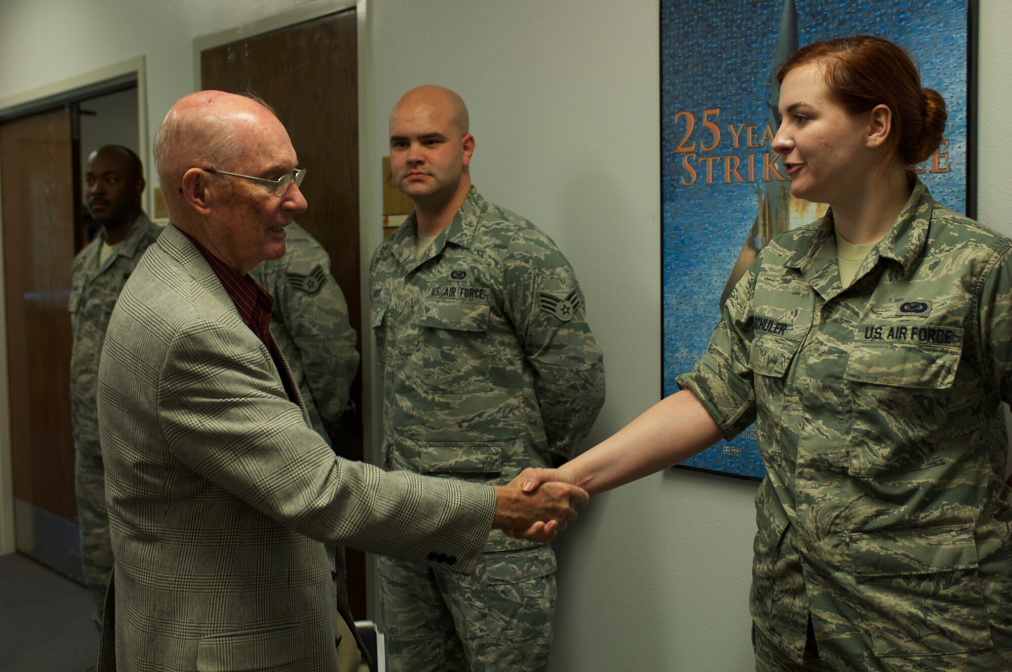 040 -- Retired Chief Master Sgt. of the Air Force James McCoy shakes hands with U.S. Air Force Senior Airman Geni Schuler, 436th Training Squadron, May 10, 2013, at Dyess Air Force Base, Texas. McCoy visited the men and women of Dyess to speak with them about his Air Force career, share his thoughts about today's military and answer questions. He also was the guest speaker for the 317th Airlift Group's Enlisted Dining-Out. (U.S. Air Force Photo by Airman 1st Class Kylsee Wisseman/Released) 
