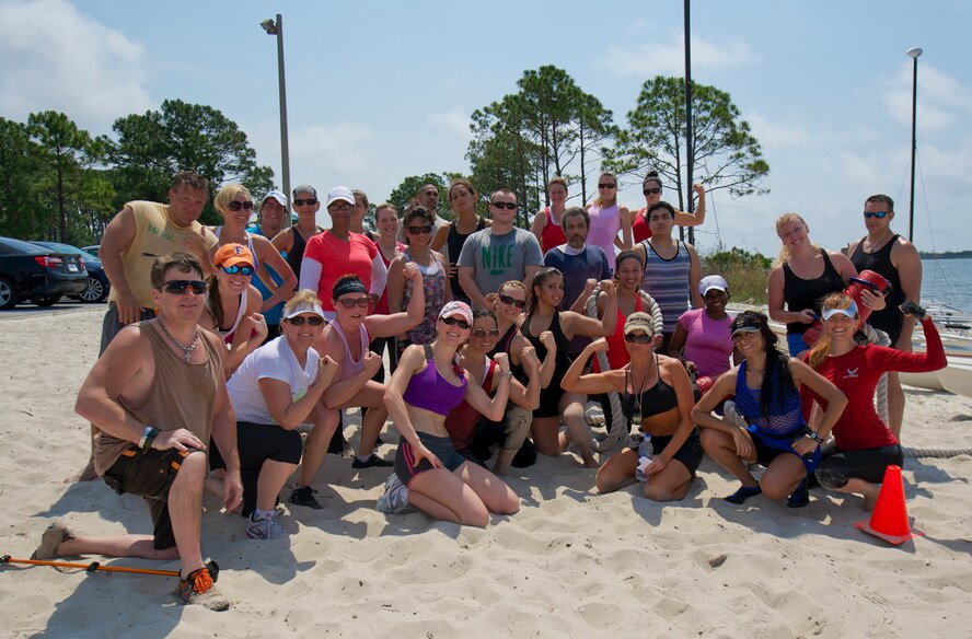 Attendees of the beach boot camp class pose for a group photo during Beach Boot Camp at the Soundside Beach on Hurlburt Field, Fla., May 18, 2013. Beach boot camp challenged participants to physically and mentally push themselves to accomplish several aerobic and strength training circuits. (U.S. Air Force Photo/ Staff Sgt. John Bainter)
