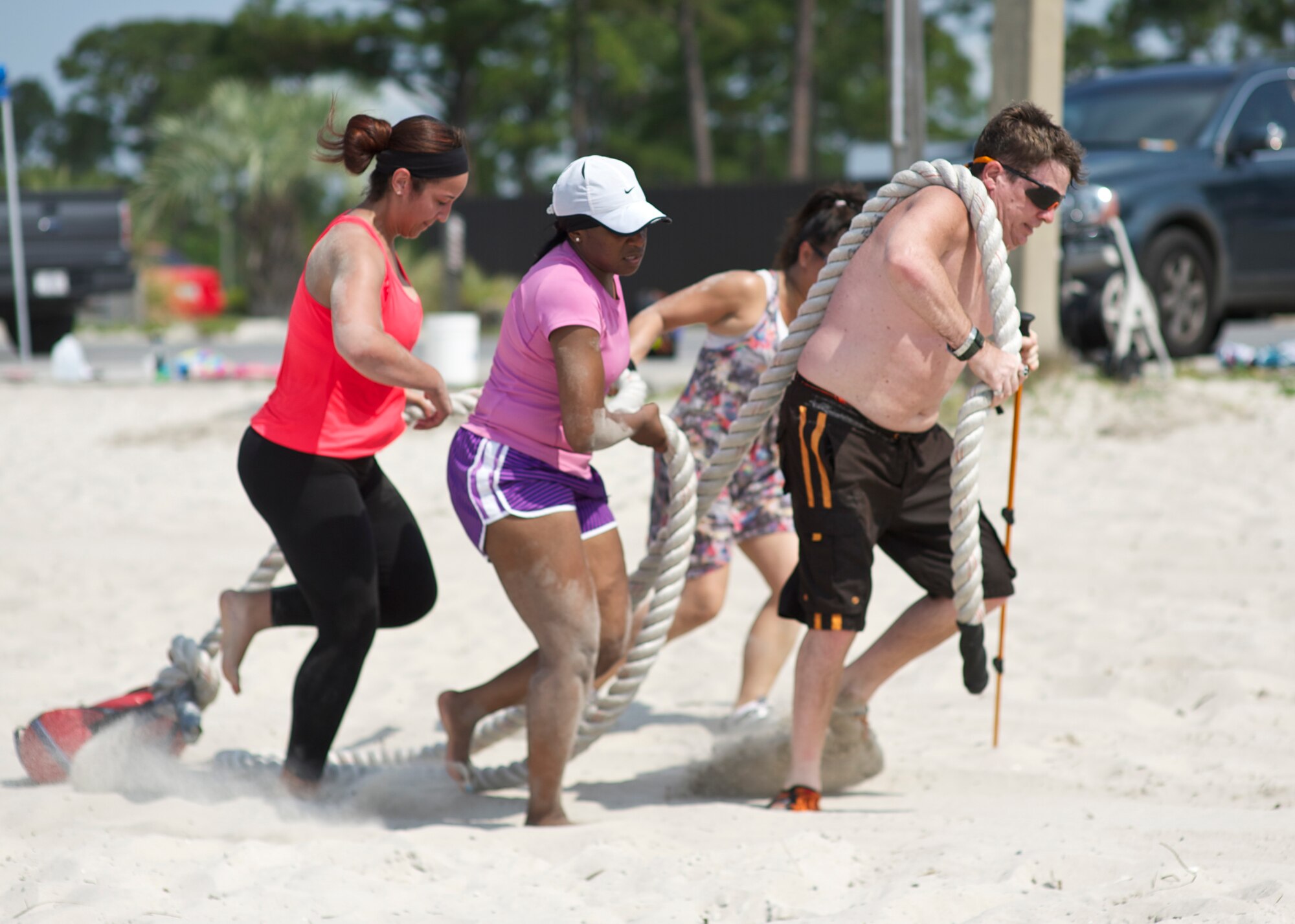 Participants help drag a heavy rope through the sand during beach boot camp at the Soundside Beach on Hurlburt Field, Fla., May 18, 2013. Many of the events encouraged teamwork and motivation to complete one physically-challenging task after another. (U.S. Air Force Photo/ Staff Sgt. John Bainter)