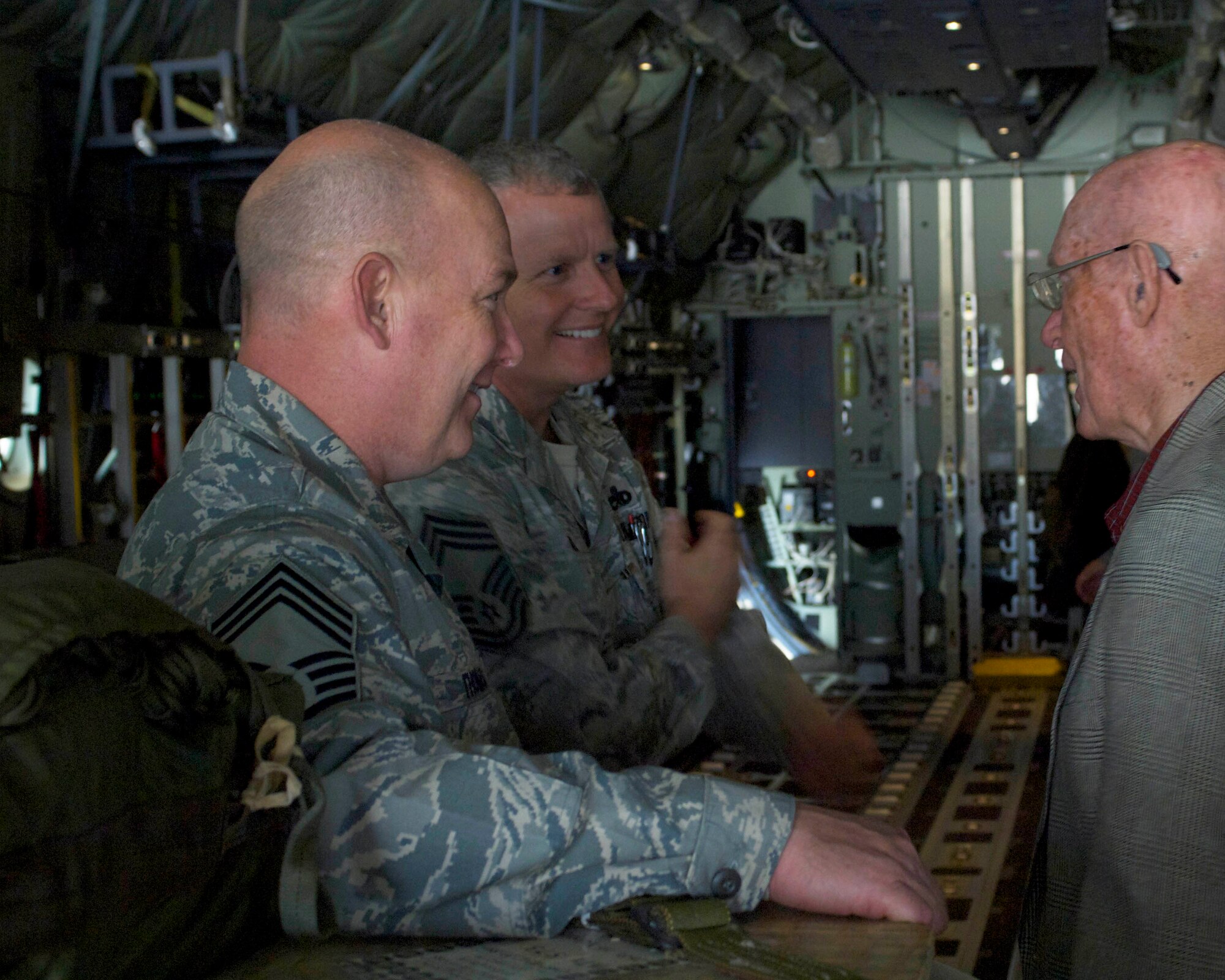 U.S. Air Force Chief Master Sgts. Hubert Thomas (left), and Michael Menard (right), 317th Aircraft Maintenance Squadron, speak with retired Chief Master Sgt. of the Air Force James McCoy May 10, 2013, at Dyess Air Force Base, Texas. During his visit McCoy toured a 317th Airlift Group C-130J and learned about the different airdrops the group executes. McCoy visited the men and women of Dyess to speak with them about his Air Force career, share his thoughts about today's military and answer questions. He also was the guest speaker for the 317th AG’s Enlisted Dining-Out. (U.S. Air Force photo by Airman 1st Class Kylsee Wisseman/Released)