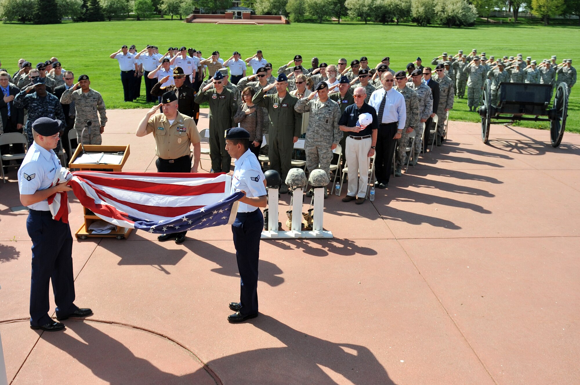 Members of the 55th Security Force Squadron fold the flag during the Police Week Retreat Ceremony at Offutt Air Force Base, Neb. May 16. Members of local law enforcement and 55th Security Forces Squadron converged on the base parade grounds to participate the ceremony during National Police Week. (U.S. Air Force photo by Jeff W. Gates/Released)