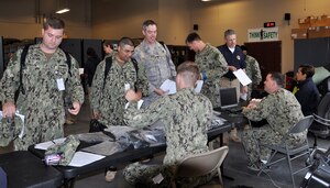 Joint Task Force Civil Support personnel receive radiation detectors and simulated medications for an exercise at Fort Eustis, Va. May 21, 2013. The exercise, known as Exercise Sudden Response 13, will take place from May 20-24, and tests the movement and capablity of JTF-CS’s equipment and personnel during the initial phases of a chemical, biological or nuclear incident. (U.S. Air Force photo by Tech. Sgt. April Wickes/Released)