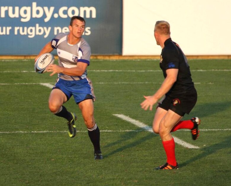 Capt. John Lockard, left, an instructor pilot with the 8th Flying Training Squadron at Vance Air Force Base, Okla., avoids an opposing player during the 2012 Armed Forces Rugby championship in Glendale, Colo. Lockard was recently selected, for the eighth time, to play on the Air Force rugby team. (Courtesy photo)