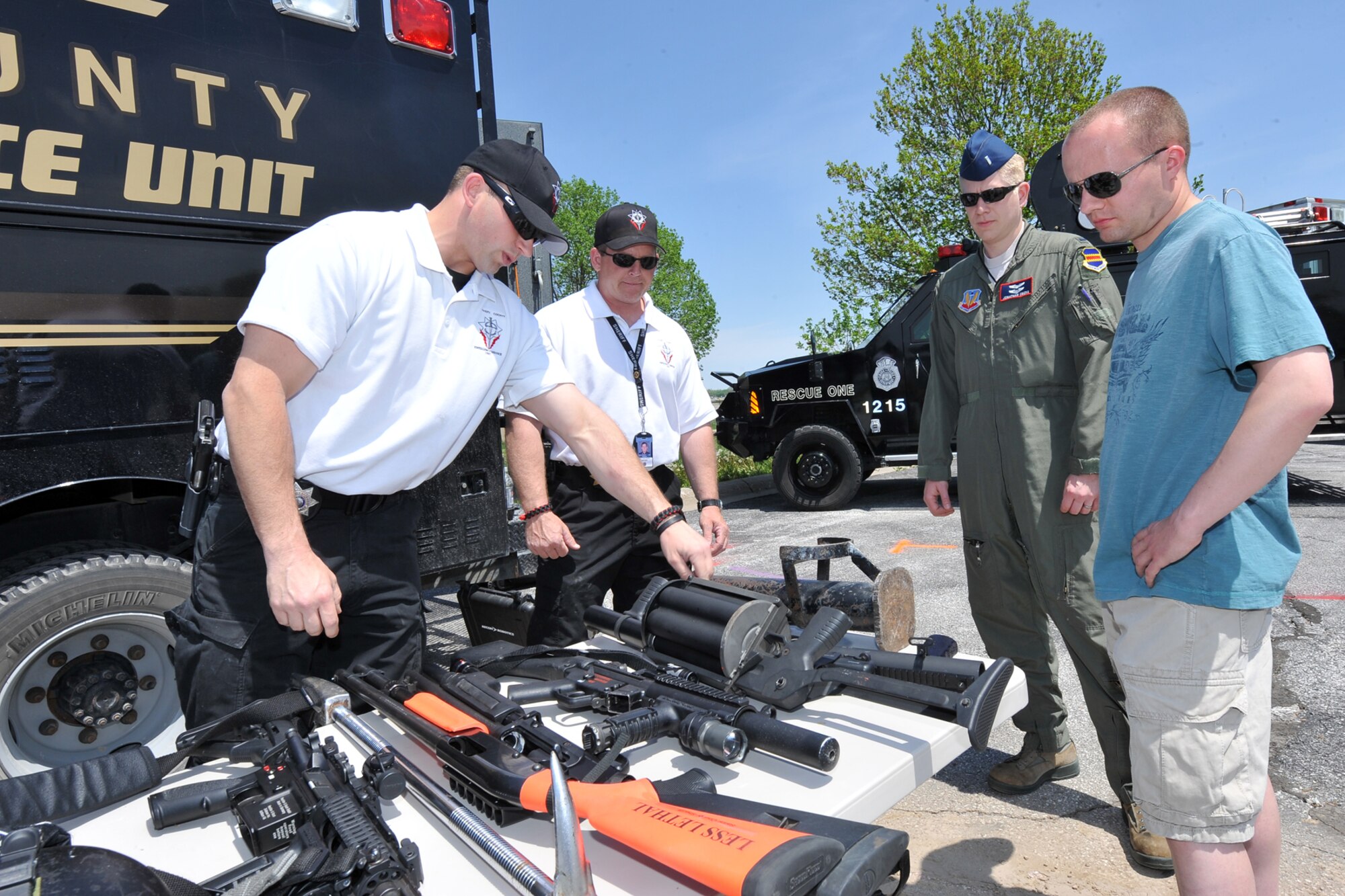 Sarpy County Sheriff Deputy Eldon Stull and Sarpy County Sheriff Sgt. Brian Fjelstad, both with the Emergency Service Unit, talk with U.S. Air Force 1st Lt. Jonathan Oberg, 38th Reconnaissance Squadron, and U.S. Air Force Senior Airman Shawn Rowe, 55th Security Forces Squadron, during Police Week outside the Base Exchange on Offutt Air Force Base, Neb., May 15.  Tens of thousands of law enforcement officers from around the world come together and participate in various events which honor those that have paid the ultimate sacrifice.  (U.S. Air Force photo by Charles Haymond/Released)