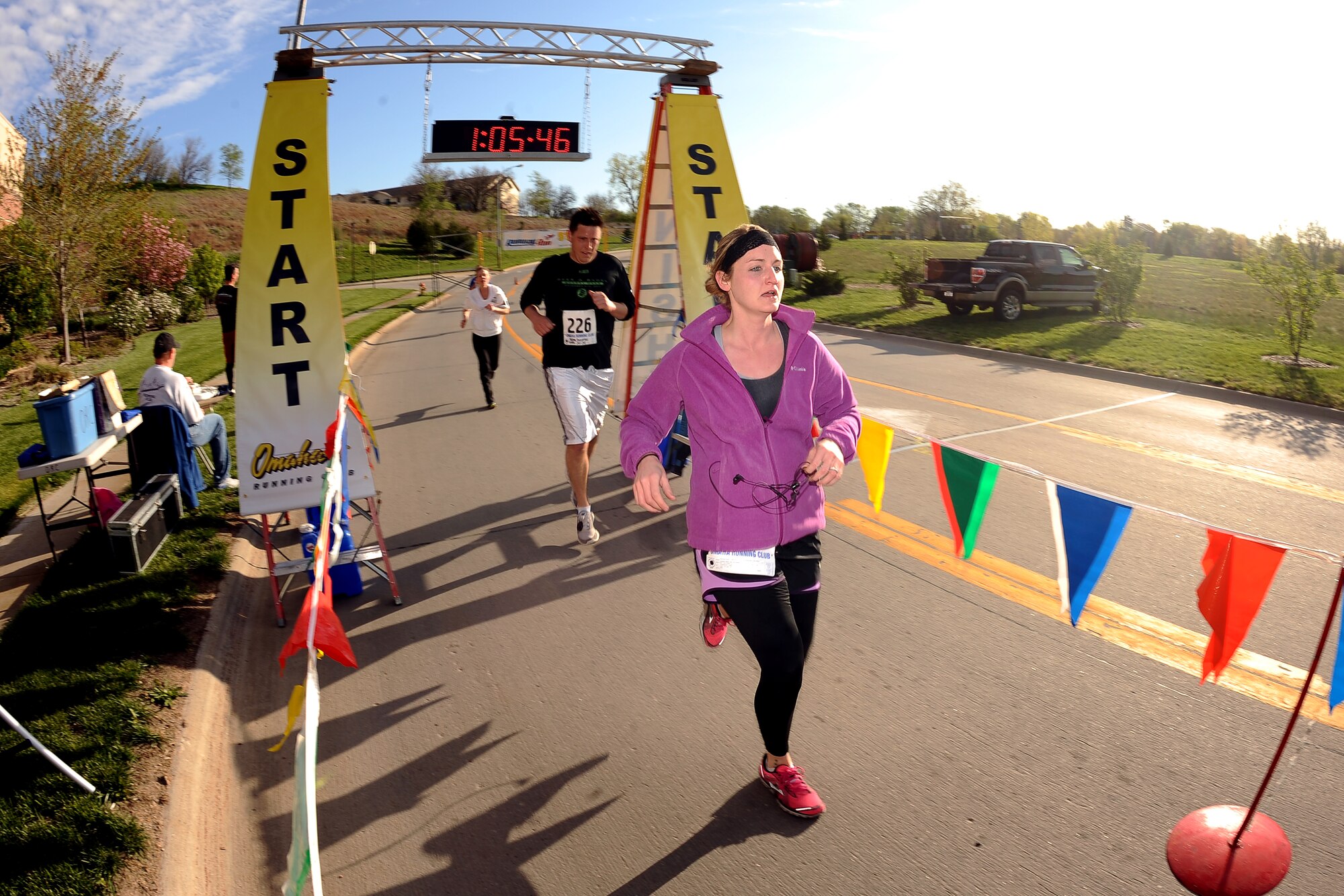 U.S. Air Force Tech. Sgt. Amey Lightfoot, 139th Medical Group in St. Joseph, Missouri, runs through the finish line, located at the Lied Activity Center in Bellevue, while participating in her second Runway Run on May 12, Offutt Air Force Base, Neb.  The unique feature of the annual run takes runners down the Offutt flightline and around the historic parts of the wing.  (U.S. Air Force photo by Josh Plueger/Released)