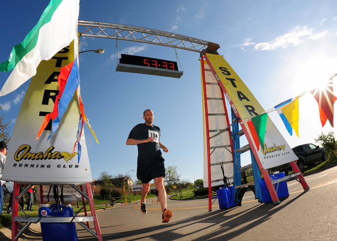 Casey Lindsey completes his seven-mile Runway Run at the finish line located at the Lied Activity Center of Bellevue.  The annual Runway Run attracts runners from around the metro for the unique opportunity to run down a military airstrip.  (U.S. Air Force photo by Josh Plueger/Released)