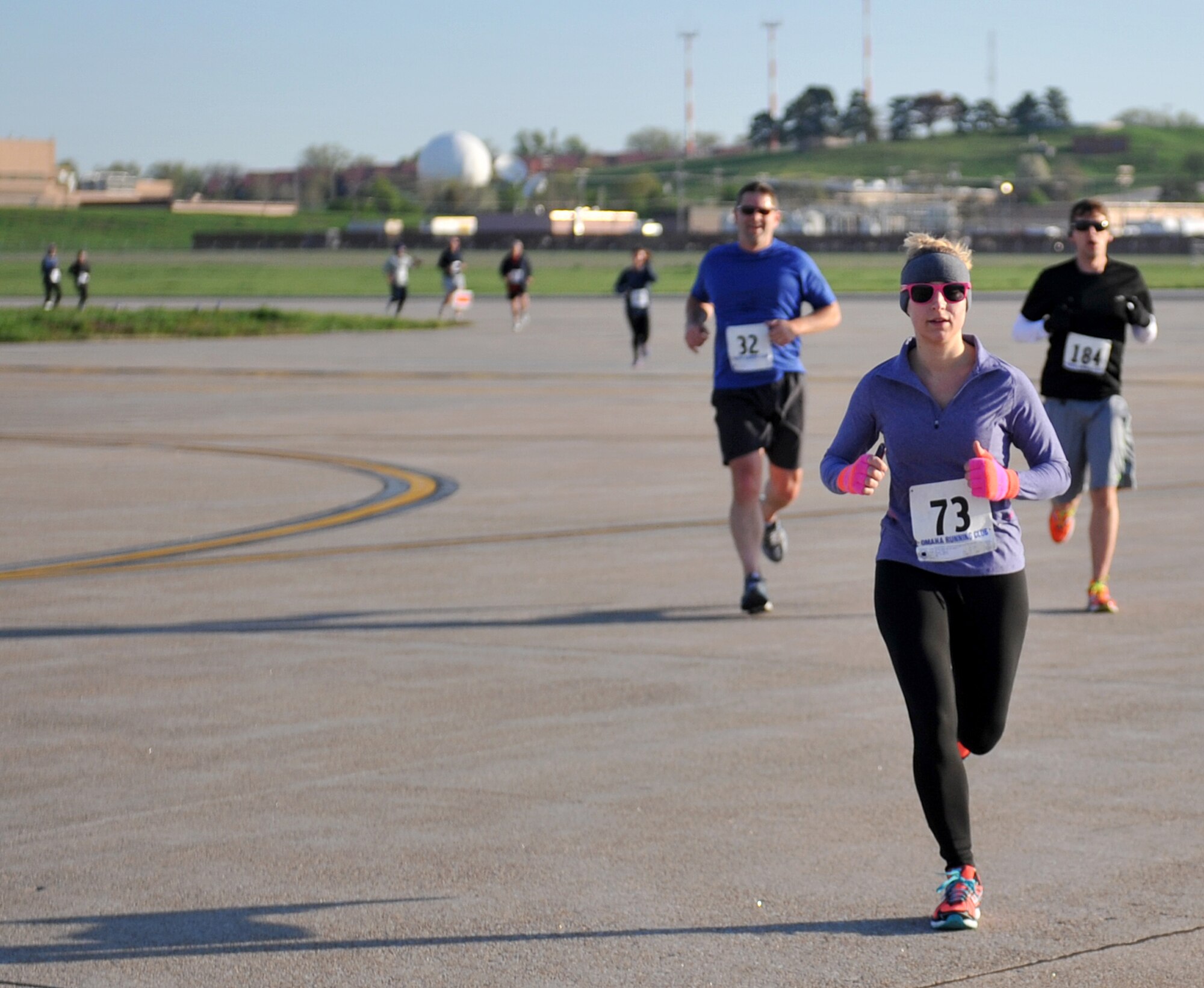 Participants make their way down the flightline while running in the annual Bellevue-Offutt Runway Run at Offutt Air Force Base, Neb., May 12. More than 200 runners participated in this unique seven-mile race that passed parked aircraft and through the historic parade grounds and housing area. (U.S. Air Force photo by Jeff W. Gates/Released)