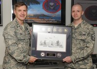 Lt. Gen. Stephen Hoog, 11th Air Force commander presents the 11th AF first sergeant of the year award to Master Sgt. Eric Mixon, 747th Communications Squadron first sergeant, at the 747th CS squadron at Joint Base Pearl Harbor-Hickam, Hawaii, May 17, 2013.  Mixon received the award for his tireless efforts and devotion to the men and women of the 747th CS. (U.S. Air Force photo/Tech. Sgt. Jerome S. Tayborn)