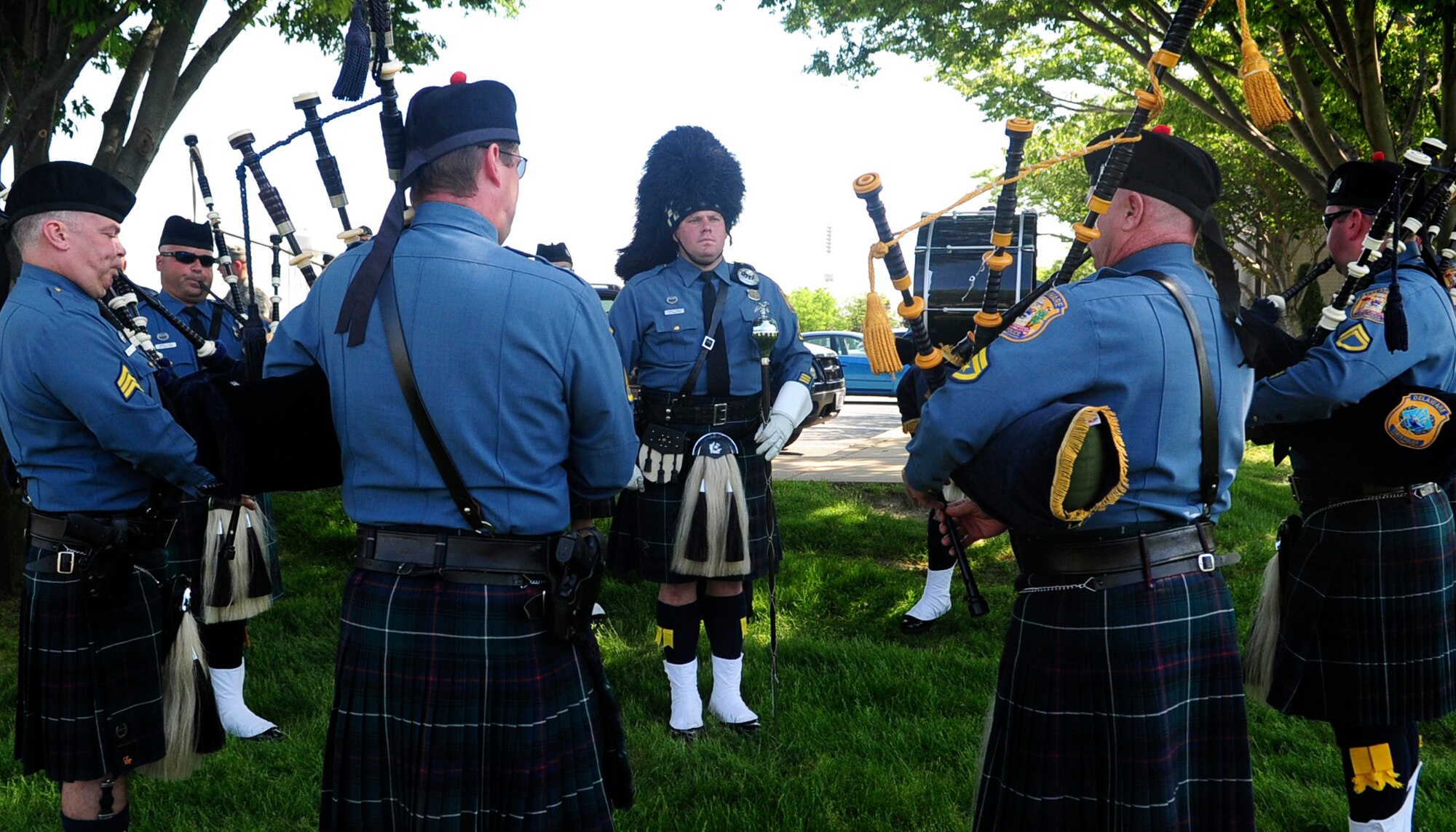 Members of the Delaware State Police Pipe and Drums Unit plays a song during a retreat ceremony May 17, 2013, at the 436th Airlift Wing headquarters building on Dover Air Force Base, Del. Law enforcement agencies from the state gathered with members of the 436th Security Forces Squadron to celebrate National Police Week and honor fallen police officers and their families. (U.S. Air Force photo/Airman 1st Class Ashlin Federick)