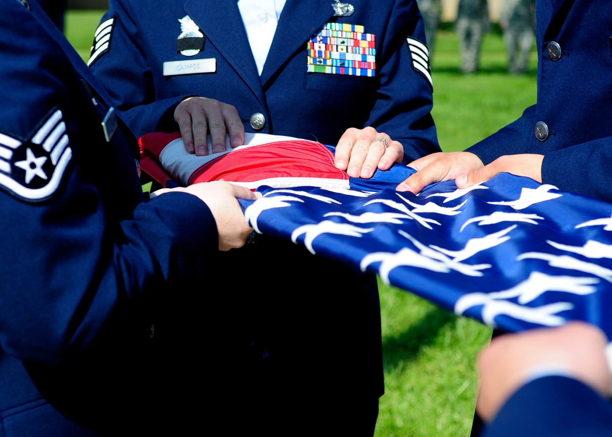 Members of the 436th Security Forces Squadron fold the flag during a retreat ceremony May 17, 2013, at the wing headquarters building on Dover Air Force Base, Del. Police departments from around the state of Delaware joined the 436th SFS at the retreat to celebrate National Police Week and honor fallen police officers and their families. (U.S. Air Force photo/Airman 1st Class Ashlin Federick)