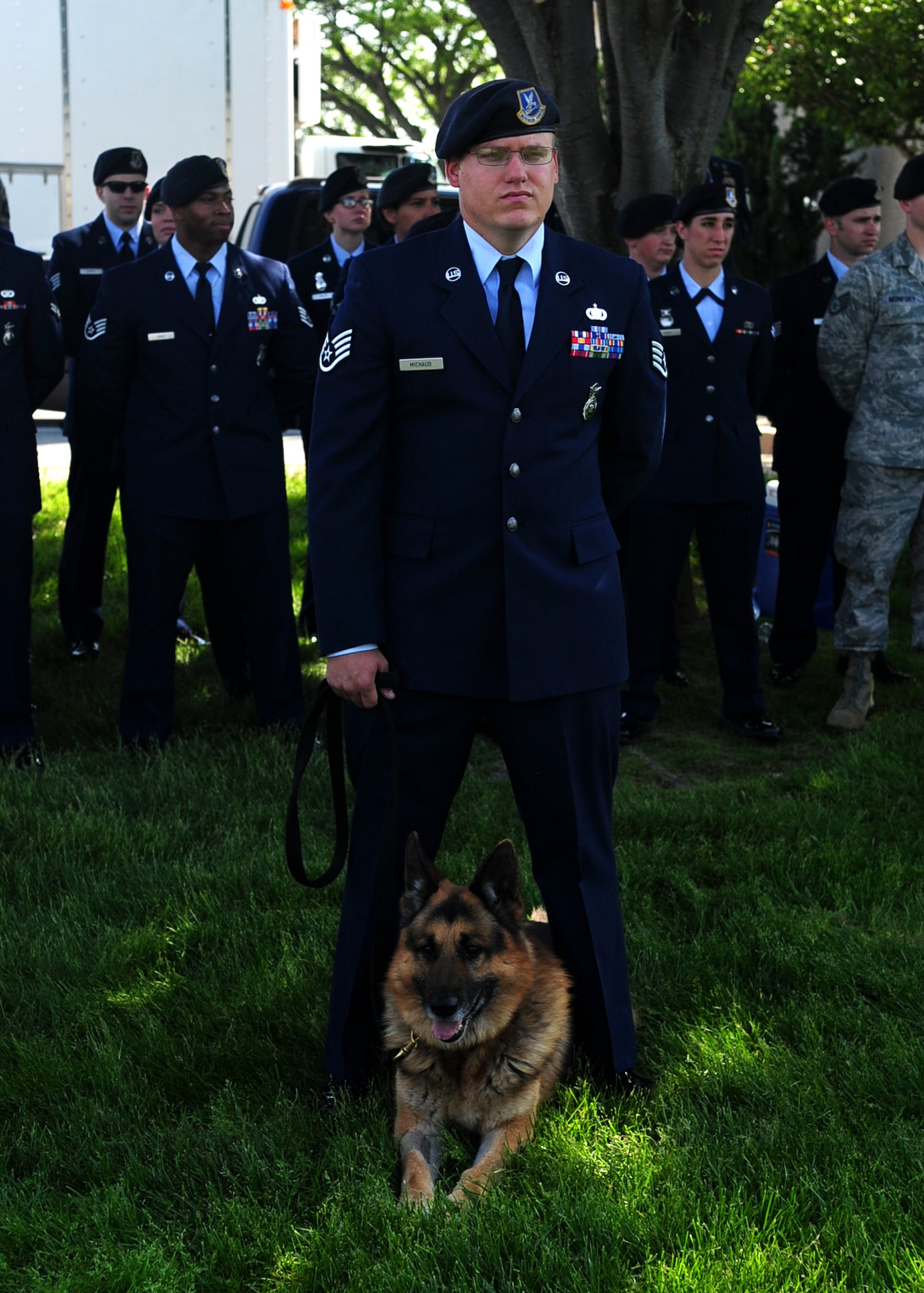 Staff Sgt. Christopher Michaud, 436th Security Forces dog handler, stands with his dog “Baddy” during a retreat ceremony May 17, 2013, at the wing headquarters building on Dover Air Force Base, Del. Police agencies from around the state of Delaware celebrated National Police Week at the retreat along with the 436th SFS. (U.S. Air Force photo/Airman 1st Class Ashlin Federick)