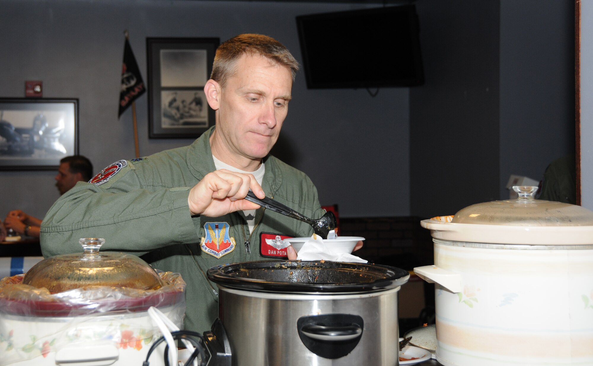 Lt. Col. Daniel J. Potas, 149th Fighter Squadron director of operations, tries one of 12 varieties of chili at the second annual Chili Cook-off sponsored by the Advanced Programs Office, May 18, 2013. The cook-off was held for the American Cancer Society in honor of the late Master Sgt. Wesley "Chili" Childress, former VaANG member, who passed away from cancer in 2011. (U.S. Air National Guard photo by Master Sgt. Carlos J. Claudio/Released)