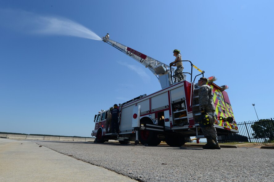 U. S. Air Force Airmen assigned to the 20th Civil Engineer squadron fire department practice ladder climbs at Shaw Air Force Base, S.C., May 16, 2013.  The firefighters train weekly on structural firefighting, aircraft firefighting, hazardous materials, rescue operations including confined space and also vehicle extrication. (U.S. Air Force photo by Airman 1st Class Nicole Sikorski/Released).