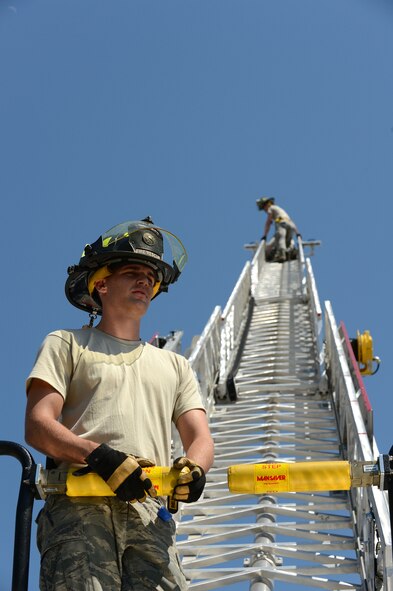 A U. S. Air Force Airman assigned to the 20th Civil Engineer squadron fire department, practice ladder climbs at Shaw Air Force Base, S.C., May 16, 2013.  The firefighters train weekly on structural firefighting, aircraft firefighting, hazardous materials, rescue operations including confined space and also vehicle extrication. (U.S. Air Force photo by Airman 1st Class Nicole Sikorski/Released).