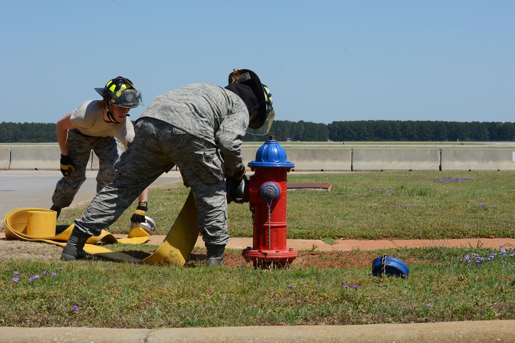 U. S. Air Force Airman 1st Class Zach Fowler and Senior Airman Charles Maxwell, both 20th Civil Engineer squadron fire department firefighters, connect a hose to a hydrant at Shaw Air Force Base, S.C., May 16, 2013.  The firefighters train weekly on structural firefighting, aircraft firefighting, hazardous materials, rescue operations including confined space and also vehicle extrication. (U.S. Air Force photo by Airman 1st Class Nicole Sikorski/Released).