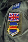 Patches of the United Kingdom flag sits above the 55th Wing shield on the sleeve of a U.K. Royal Air Force members sitting in an aircrew training session with a focus on flight equipment at the Bennie Davis Maintenance Facility April 15 at Offutt Air Force Base, Neb.  The RAF has been a staple at the 55th Wing since January 2011 when they started participating in RC-135 Rivet Joint initial qualification training here. (U.S. Air Force Photo by Josh Plueger/Released)