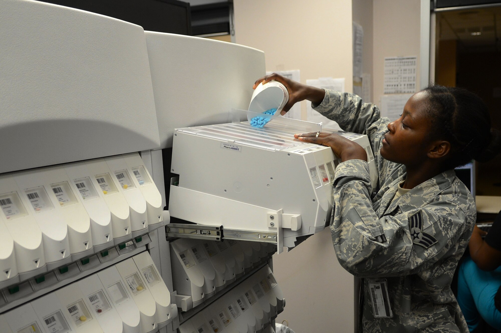 U.S. Air Force Senior Airman Erika McCrea, 20th Medical Group pharmacy technician, fills a prescription at Shaw Air Force Base, S.C., May 16, 2013.  McCrea handles 500 different types of medication that the pharmacy stocks, dispenses 5,000 prescriptions a week and helps serve 31,000 beneficiaries, which include active-duty service members, dependents and retirees. (U.S. Air Force photo by Airman 1st Class Nicole Sikorski/Released)