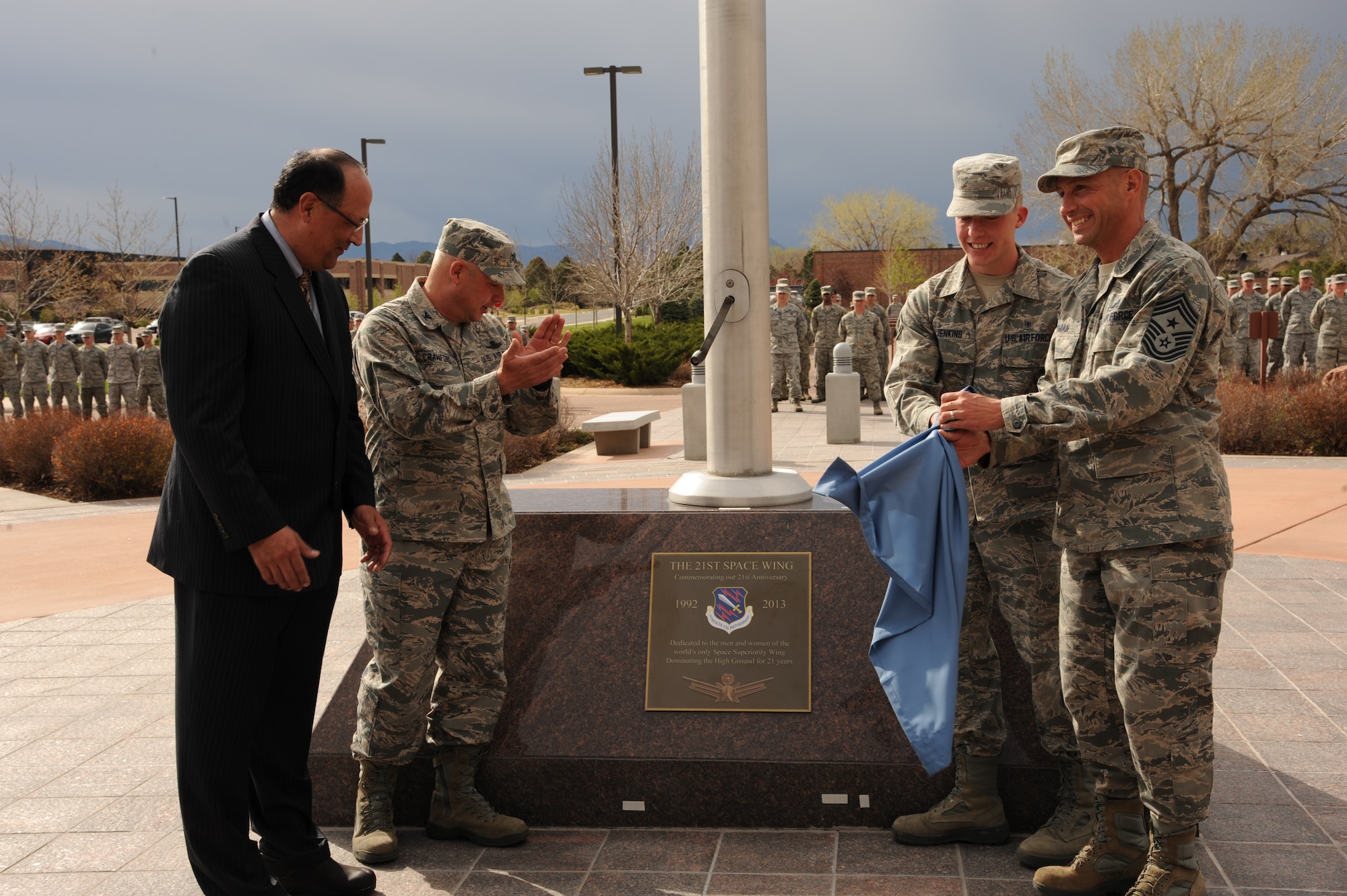PETERSON AIR FORCE BASE, Colo. – (Left to right) Randy Rocha, Five Star Bank; Col. Chris Crawford, 21st Space Wing commander; Airman Qadry Jenkins, 21st Dental Squadron; and Chief Master Sgt. Richard Redman, 21st SW command chief, unveil the 21st Space Wing’s 21st anniversary plaque May 14 in front of the wing headquarters. The wing marked its 21st anniversary May 15 with a week of anniversary events, culminating with a dinner May 17 at The Club. (U.S. Air Force photo/Staff Sgt. Aaron Breeden)