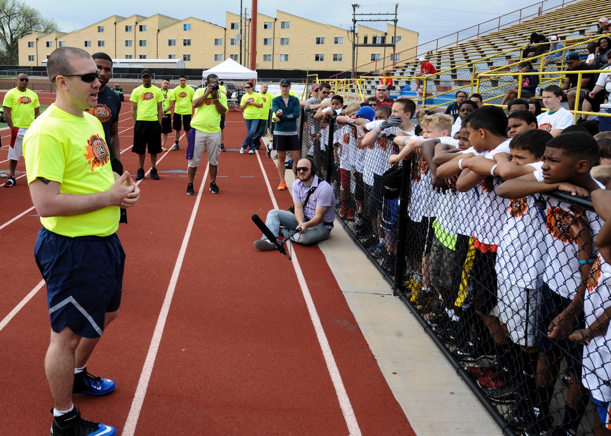 Kyle Carpenter speaks to children at the 16Ways football camp May 18, 2013, at the Aurora Public Stadium, Aurora, Colo. Carpenter, an Air Force staff sergeant with the Air Reserve Personnel Center, delivered opening comments about what teamwork means in the Air Force. The camp gave more than 200 children between the ages of 8 and 14 an opportunity to enhance their football skills and learn the importance of teamwork and anti-bullying.  (U.S. Air Force photo by Staff Sgt. Christopher Gross/Released)