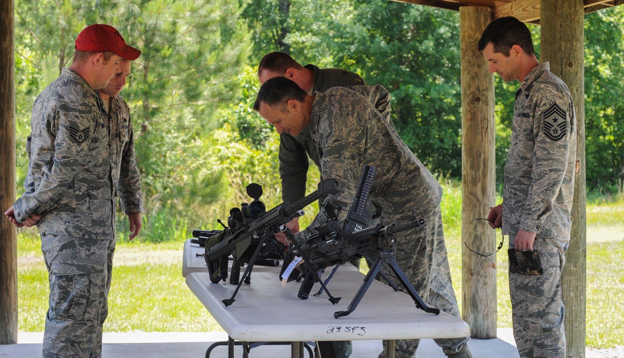 U.S. Air Force Col. Billy Thompson, 23d Wing Base commander, and Chief Master Sgt. Mathew Wells, 23d Wing command chief, look at a weapons display at Moody Air Force Base, Ga., on May 15, 2013. The weapons were on display to show the many different types that are available at Moody. (U.S. Air Force photo by Airman Alexis Grotz/ Released)