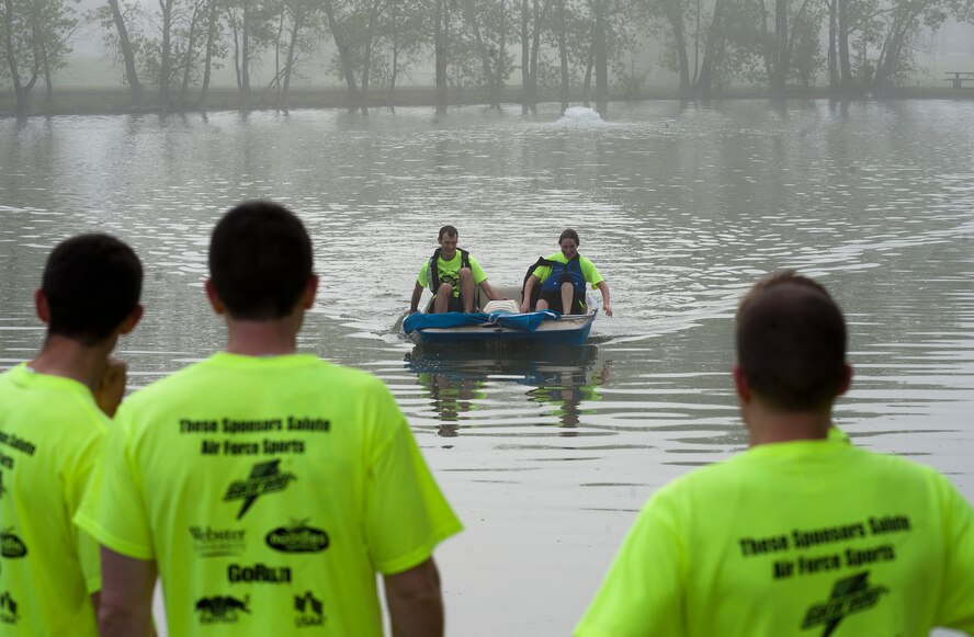 Airmen from the 350th Air Refueling Squadron watch as their teammates finish the boat race May 17, 2013, McConnell Air Force Base, Kan. This race was one of many events during the second annual Amazing Race, a competition between squadrons to help promote espirit de corp . (U.S. Air Force photo/Airman 1st Class Colby L. Hardin)