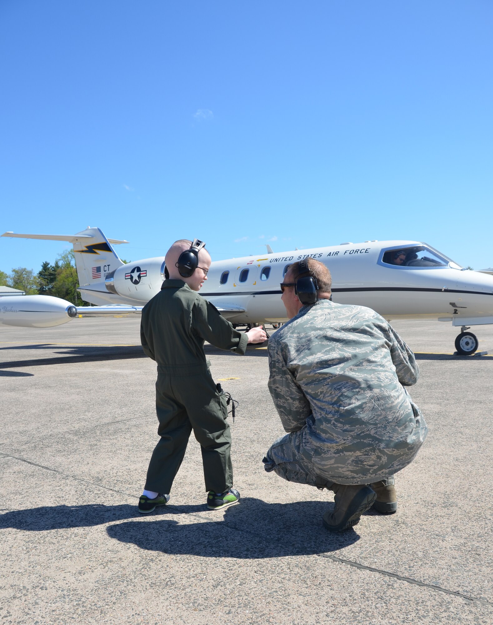 Logan Schoenhardt and Master Sgt. Jonathan Favreau discuss the finer points of launching a jet during the Pilot for A Day Program at Bradley Air National Guard Base, East Granby, Conn., May 3, 2013. (Air National Guard photo by 1st Lt. Dawn Surprenant//Released)