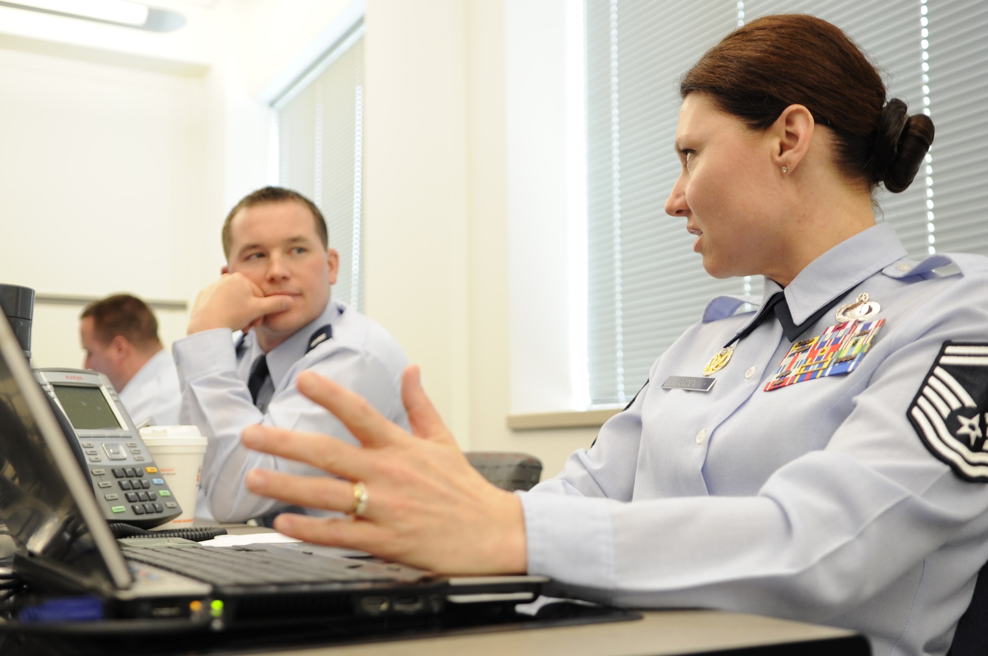 Capt. Shaun Carney (left) and Senior Master Sgt. Joanna Ogden discuss routing choices for an idea submitted to the Every Dollar Counts program May 7, 2013, in the Airmen Innovation Operations Center at the Pentagon, Washington, D.C. The AIOC is the hub of Every Dollar Counts, where Airmen manning the center filter the ideas to the respective units to be routed and answered.  (U.S. Air Force photo/Senior Airman Carlin Leslie)