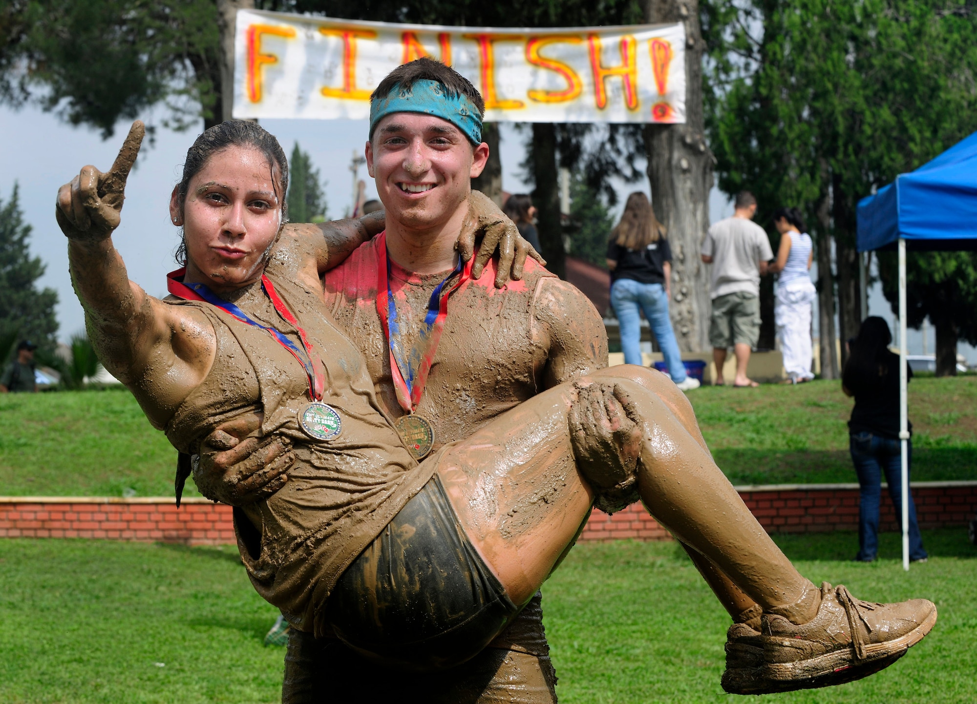Members of Team Incirlik hold up one finger symbolizing number one after finishing in first place for the cooperative category during the Ultimate Dirty Dash 3 May 18, 2013, at Incirlik Air Base, Turkey. Participants had to endure 21 separate obstacles during the event. (U.S. Air Force photo by Senior Airman Anthony Sanchelli/Released)
