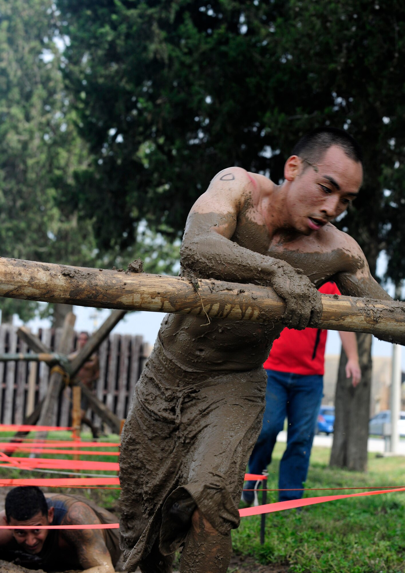 A member of Team Incirlik scales over a log after crawling through a thick mud pit during the Ultimate Dirty Dash 3 May 18, 2013, at Incirlik Air Base, Turkey. Between mounds of mud, deep mud pits and mud filled tunnels, contestants were bound to get dirty during the event. (U.S. Air Force photo by Senior Airman Anthony Sanchelli/Released)
