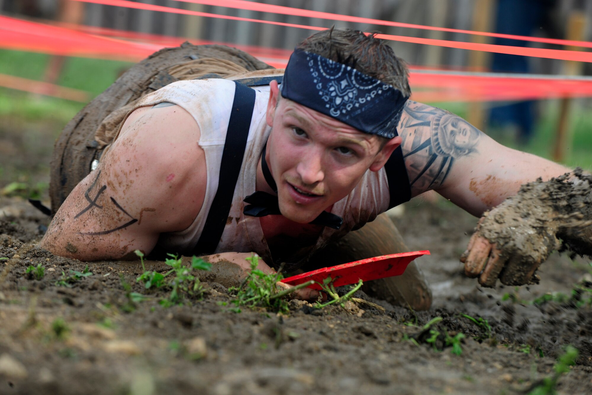 A member of Team Incirlik trudges through a thick mud pit during the Ultimate Dirty Dash 3 May 18, 2013, at Incirlik Air Base, Turkey. Participants had to endure 21 separate obstacles during the event. (U.S. Air Force photo by Senior Airman Anthony Sanchelli/Released)
