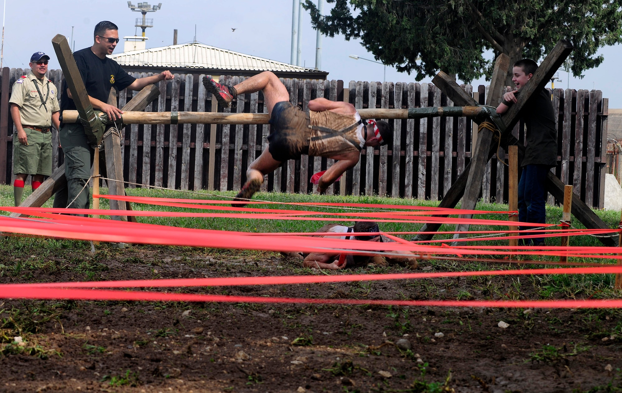 Members of Team Incirlik scale over a log before low crawling in a thick mud pit during the Ultimate Dirty Dash 3 May 18, 2013, at Incirlik Air Base, Turkey. Participants had to endure 21 separate obstacles during the event. (U.S. Air Force photo by Senior Airman Anthony Sanchelli/Released)
