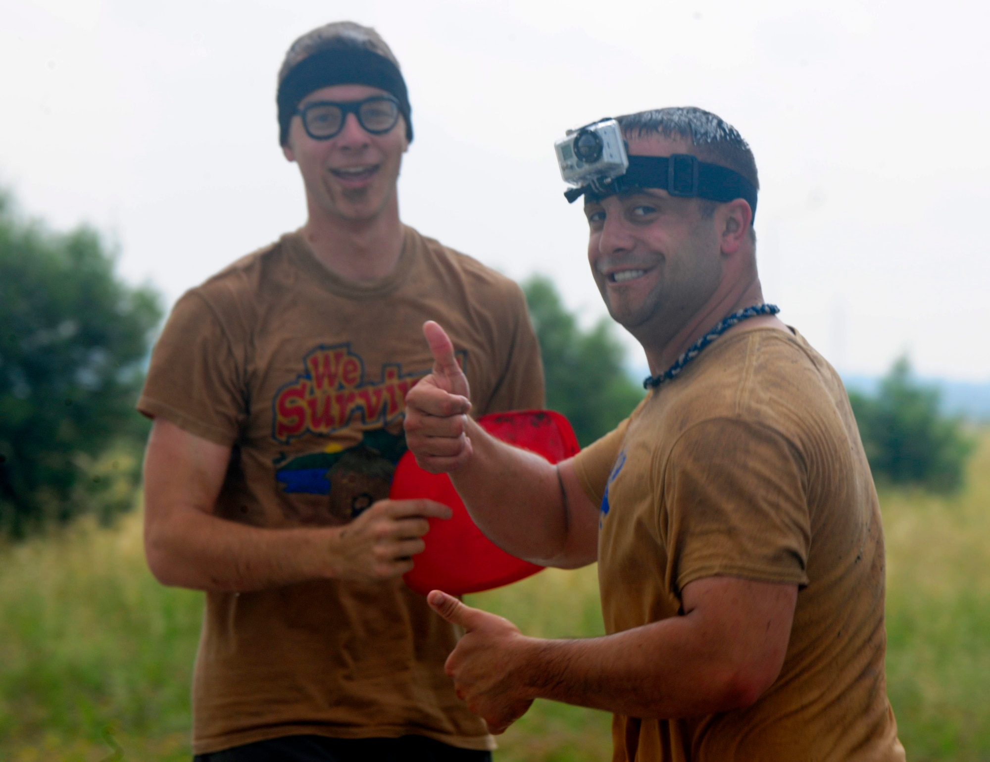 Pete Ising, right, gives a thumbs up with his partner Stephen Jarman during the Ultimate Dirty Dash 3 May 18, 2013, at Incirlik Air Base, Turkey. Between mounds of mud, deep mud pits and mud filled tunnels, contestants were bound to get dirty during the event. (U.S. Air Force photo by Senior Airman Anthony Sanchelli/Released)
