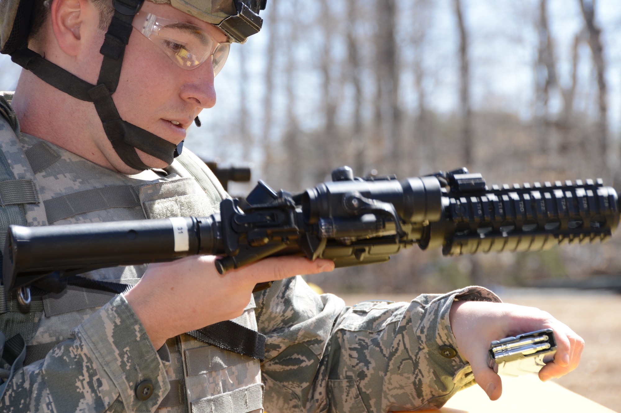 Staff Sgt. Patrick Glennon with the 103rd Security Forces Squadron reloads his M-4 rifle during the shoot, move and communicate  training at Bradley Air National Guard Base, East Granby, Conn., April 6, 2013.  (Air National Guard photo by  Senior Airman Manny Santiago/Released)