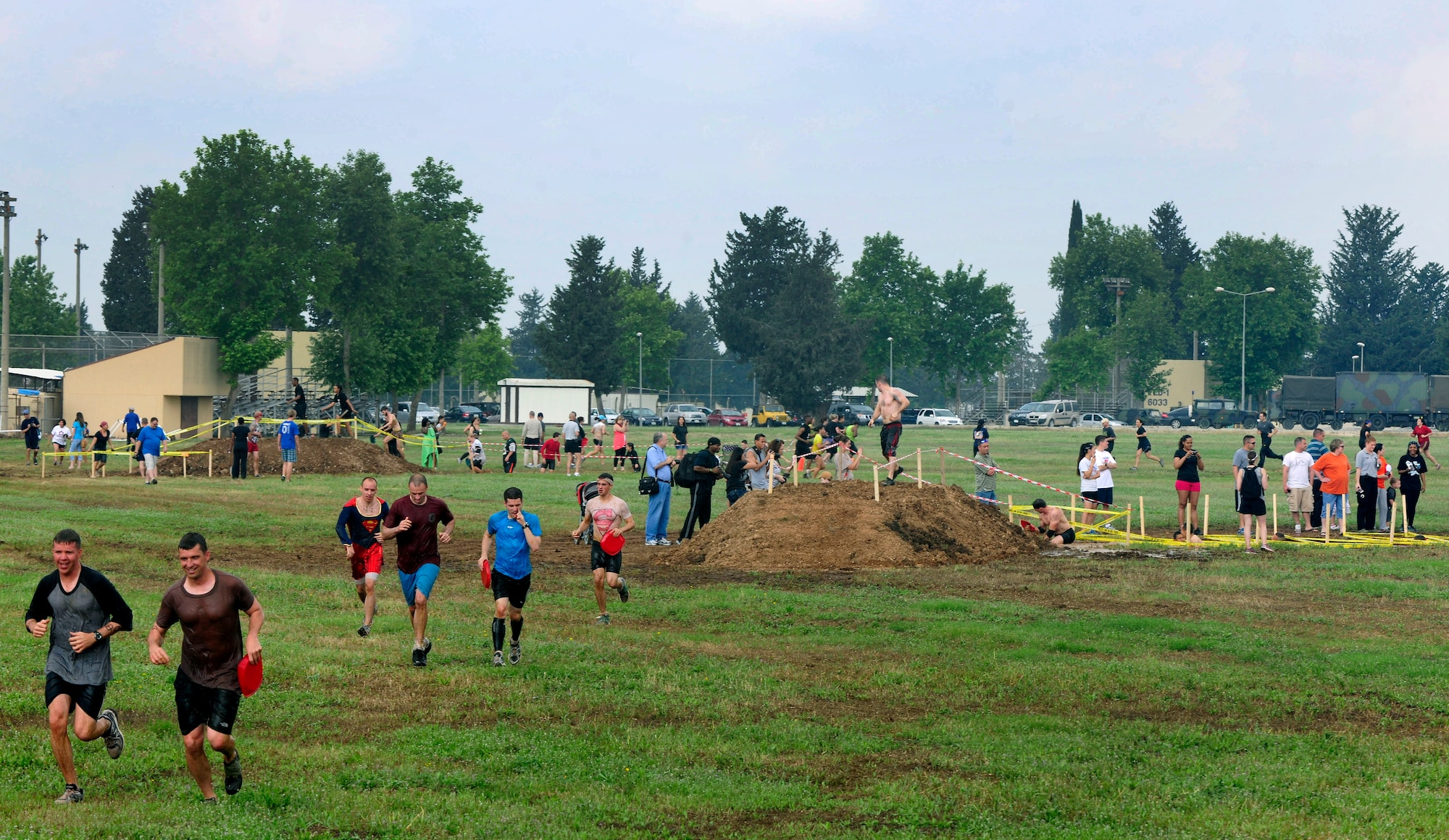 Members of Team Incirlik hustle over mounds of mud during the Ultimate Dirty Dash 3 May 18, 2013, at Incirlik Air Base, Turkey. Participants had to endure 21 separate obstacles during the event. (U.S. Air Force photo by Senior Airman Anthony Sanchelli/Released)
