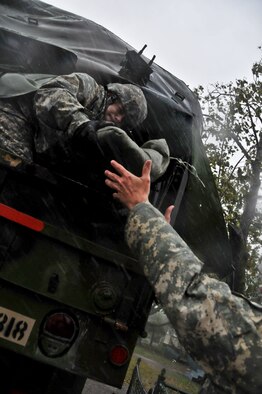 New Jersey Army National Guardsman Staff Sgt. Kenneth Williams hands sand bags out the back of a M35 2 1/2 ton cargo truck Oct. 29, 2012, in Atlantic City, N.J., in support of local residents during hurricane Sandy. (U.S. Air Force photo/Tech. Sgt. Matt Hecht)