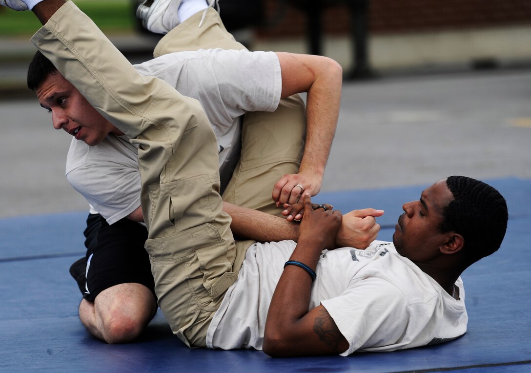 Staff Sgts. Josh Montoya and Jesus Cosme, 11th Security Forces Group instructors, execute combative techniques during the National Police Week Tactical First Responders Demonstration on May 17, 2013 at Joint Base Andrews, Md. (U.S. Air Force photo/ Airman 1st Class Nesha Humes)