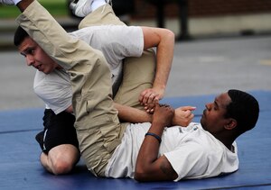 Staff Sgts. Josh Montoya and Jesus Cosme, 11th Security Forces Group instructors, execute combative techniques during the National Police Week Tactical First Responders Demonstration on May 17, 2013 at Joint Base Andrews, Md. (U.S. Air Force photo/ Airman 1st Class Nesha Humes)