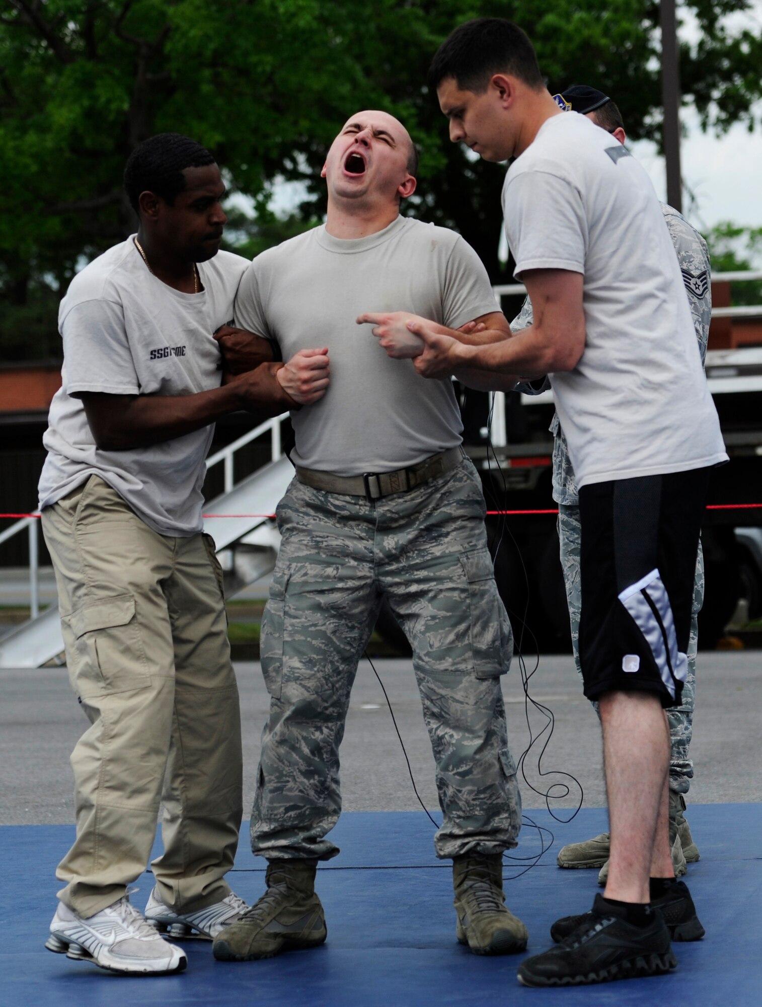 Staff Sgt. Matthew Juhnke, 11th Civil Engineer Squadron explosive ordinance disposal journeyman, demonstrates the effects of being tazed during the National Police Week Tactical First Responders Demonstration on May 17, 2013 at Joint Base Andrews, Md. (U.S. Air Force photo/ Airman 1st Class Nesha Humes)