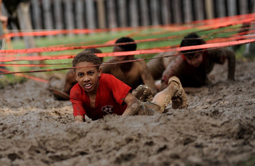 Participants low crawl through the final mud pit during the Ultimate Dirty Dash 3 May 18, 2013, at Incirlik Air Base, Turkey. The event was hosted by Incirlik's Top 3 to promote fitness and camaraderie, and to give the base community a chance to socialize and have fun. (U.S. Air Force photo by Senior Airman Jarvie Z. Wallace/Released)  