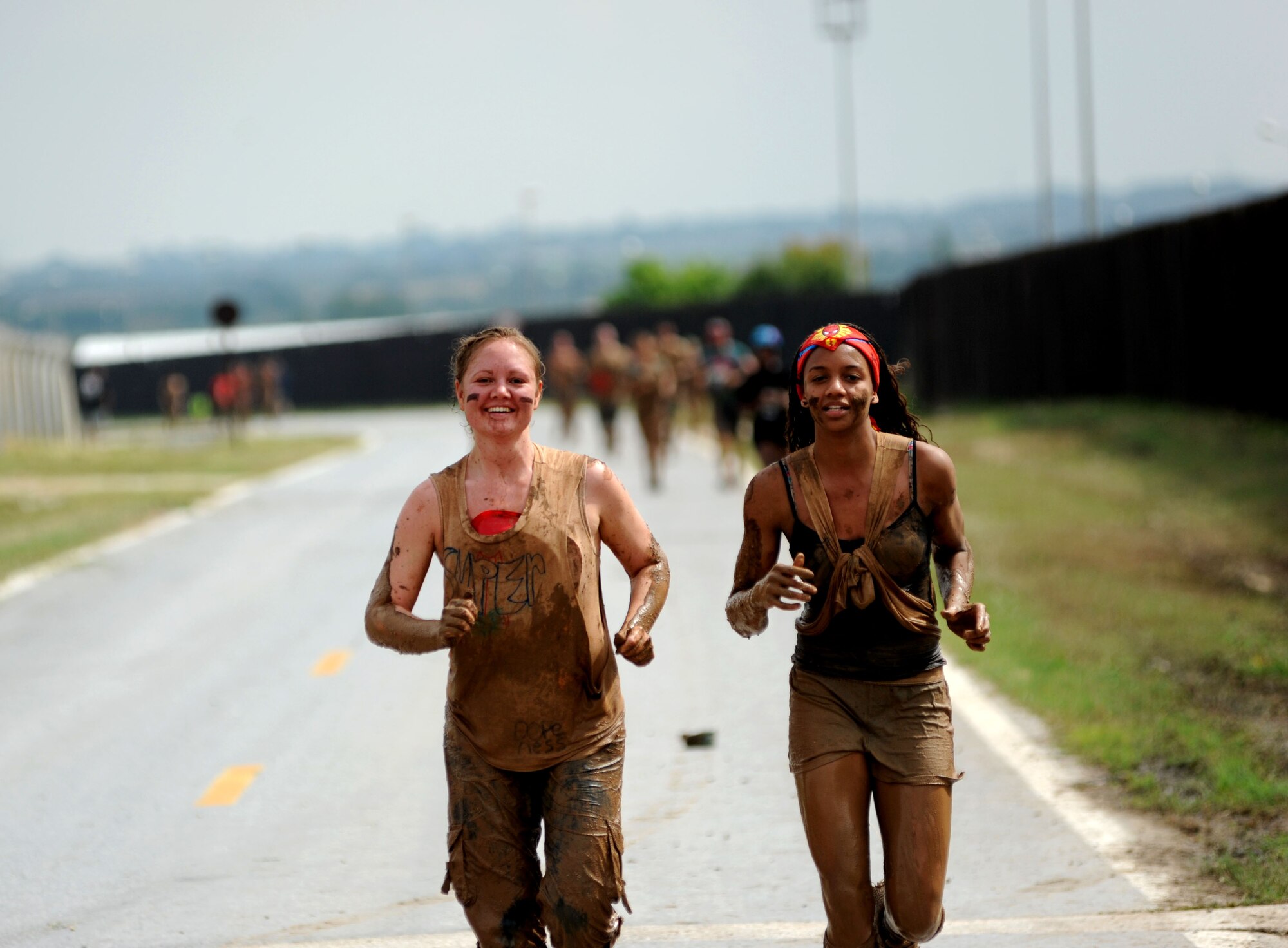 Tabitha Jones, 39th Comptroller Squadron, and her daughter run between obstacles during the Ultimate Dirty Dash 3 May 18, 2013, at Incirlik Air Base, Turkey.  The event was hosted by Incirlik's Top 3 to promote fitness and camaraderie, and to give the base community a chance to socialize and have fun. (U.S. Air Force photo by Senior Airman Jarvie Z. Wallace/Released) 